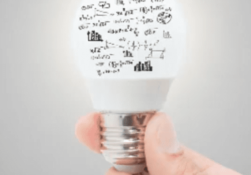 Lightbulb with hand holding, covered in math equations.